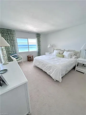 a bedroom with bed and window