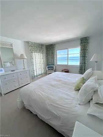 a bedroom with a large bed and a large window