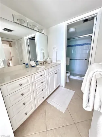 a bathroom with a double vanity sink and mirror