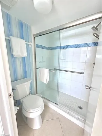 a bathroom with a toilet and a shower