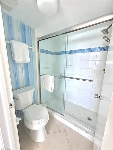 a bathroom with a toilet and a shower