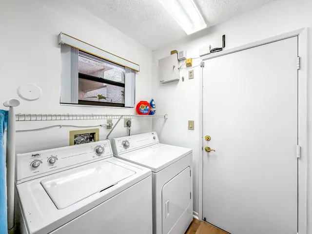 a view of a house with a big yard and potted plants