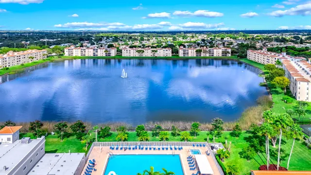 a living room with stainless steel appliances lots of furniture and kitchen view