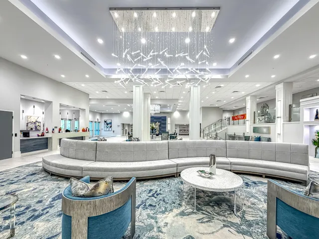 a large room with lots of furniture and a wooden floor