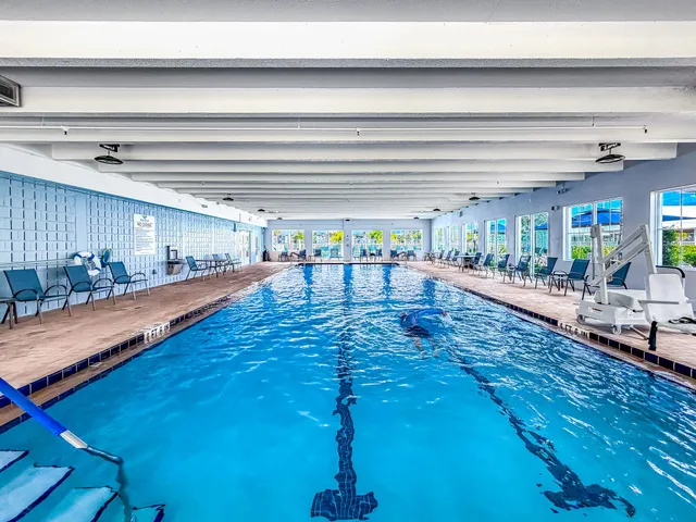 a view of a swimming pool with an outdoor space and seating area