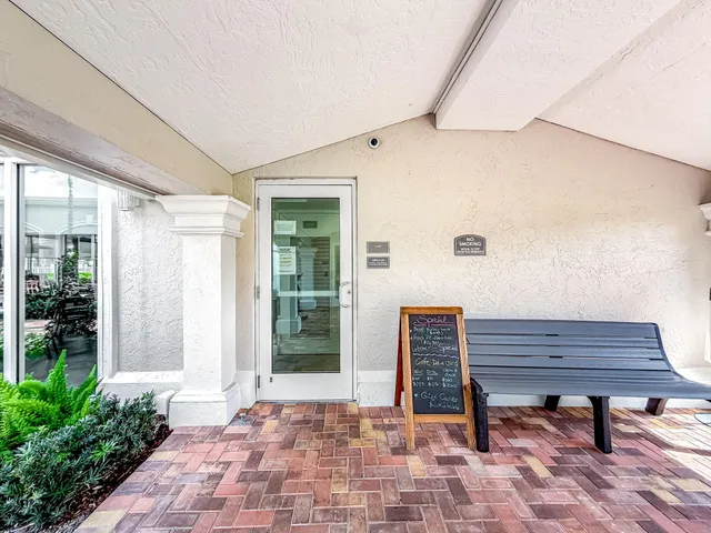 a view of a garage with a dining table and chairs