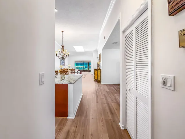 a kitchen with stainless steel appliances granite countertop wooden cabinets a sink dishwasher and a stove top oven