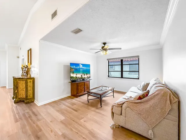 a living room with furniture a rug and a chandelier
