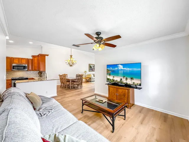 a view of a dining room with furniture wooden floor and a chandelier