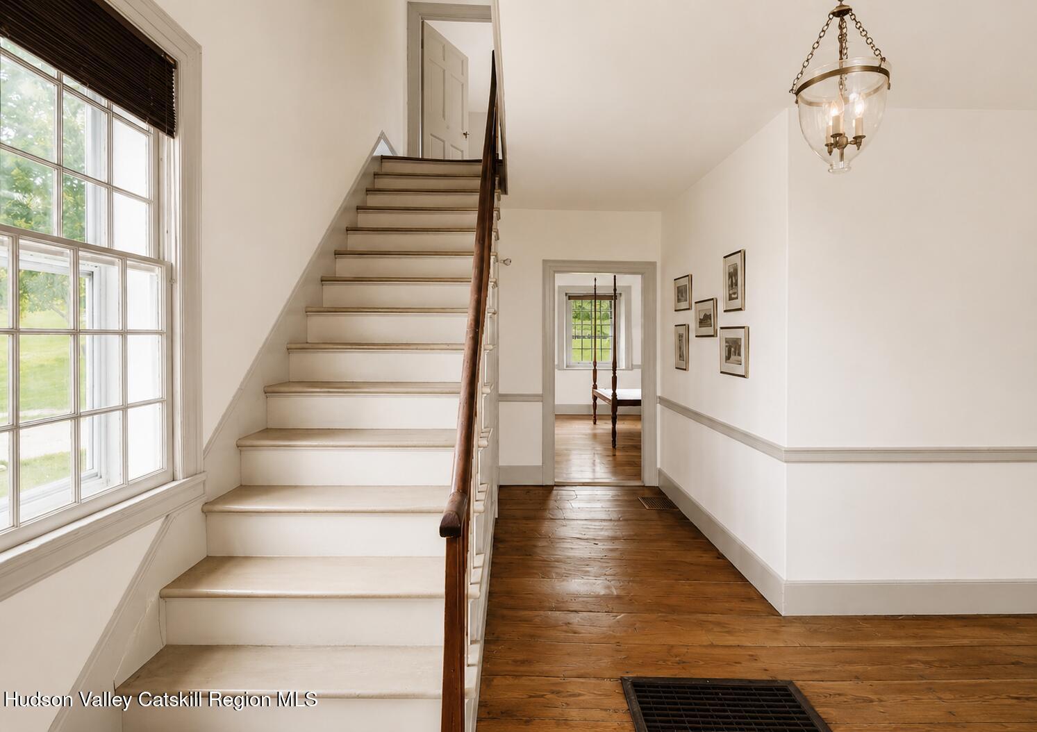 652 Albany Post Road New Paltz, NY 12561 - Photo 7 of 36 a view of staircase with white walls and wooden floor