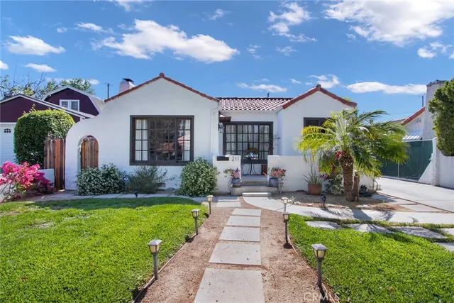 a front view of a house with garden