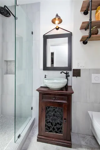 a bathroom with a sink a mirror and shower