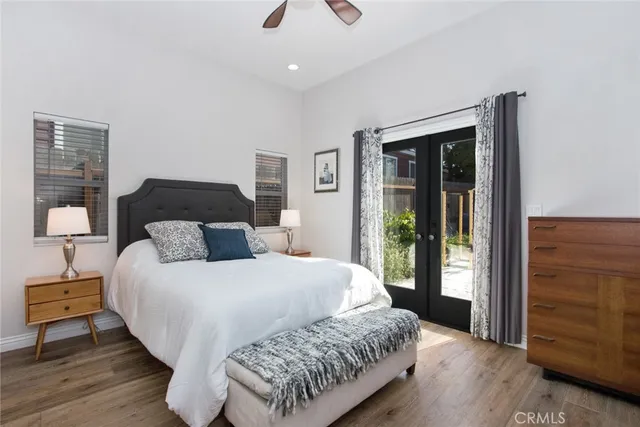 a bedroom with a bed and wooden floor