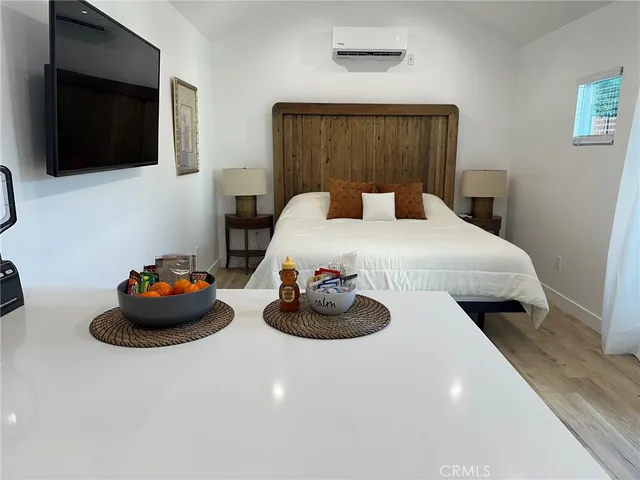 a bedroom with a bed and flat screen tv
