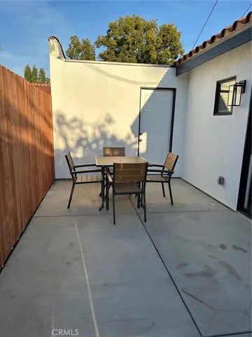 a patio with table and chairs