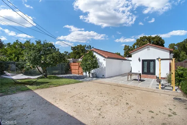 a row of palm trees in front of a house