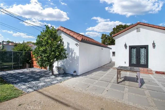 a backyard of a house with table and chairs