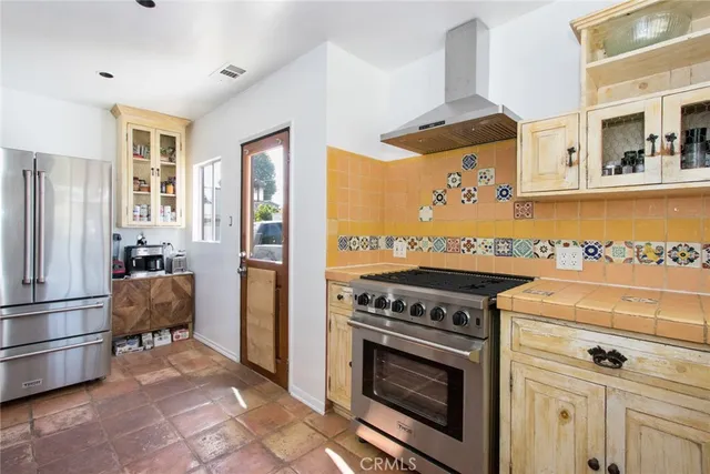 a kitchen with a stove and a refrigerator