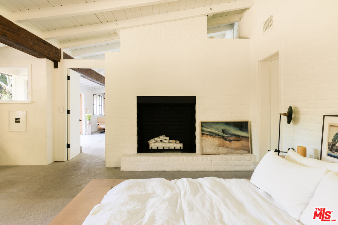 1830 Old Orchard Road Los Angeles, CA 90049 - Photo 16 of 30 a bedroom with a bed and a view of bathroom