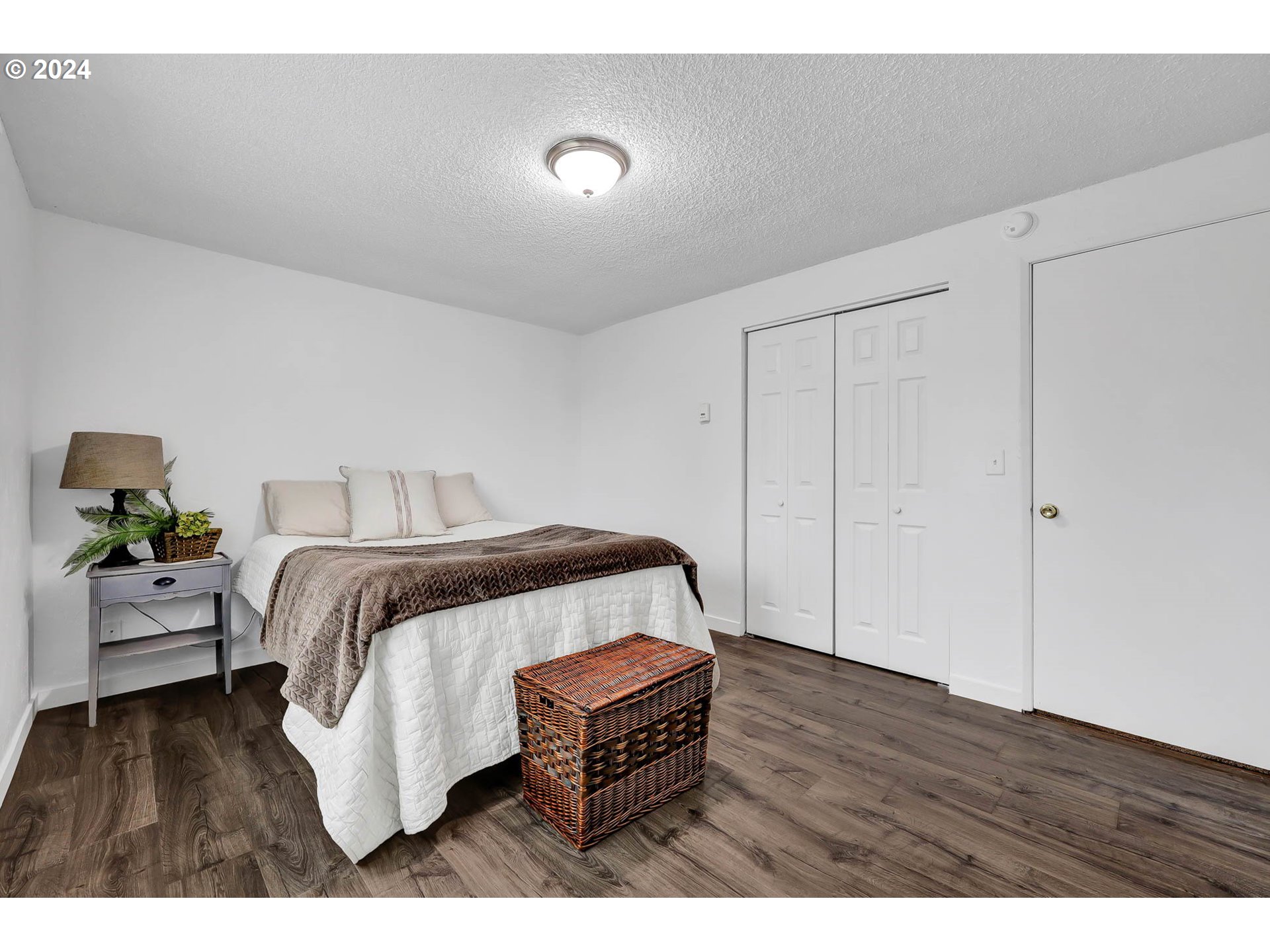 4250 Scenic Drive Eugene, OR 97404 - Photo 15 of 31 a bedroom with a bed and wooden floor