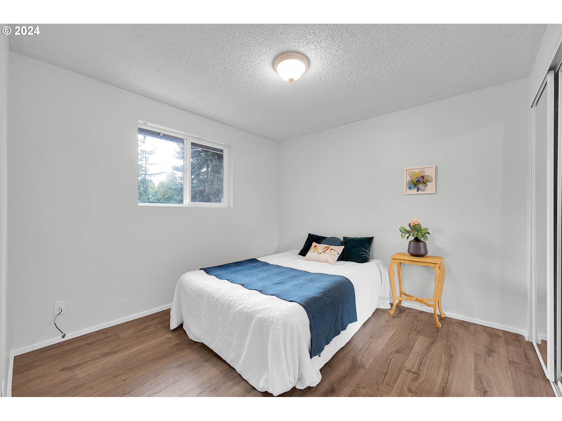 4250 Scenic Drive Eugene, OR 97404 - Photo 27 of 31 a bedroom with a bed and painting on the wall