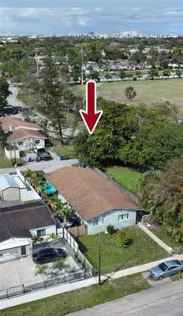 an aerial view of a house with a yard and lake view