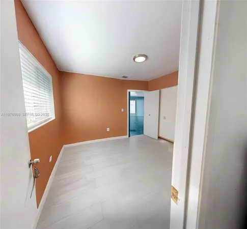 a view of an empty room and a window
