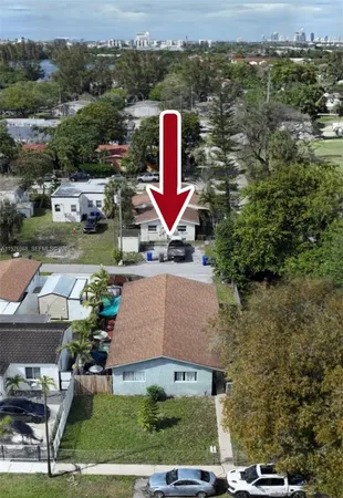 an aerial view of a house with a yard and lake view