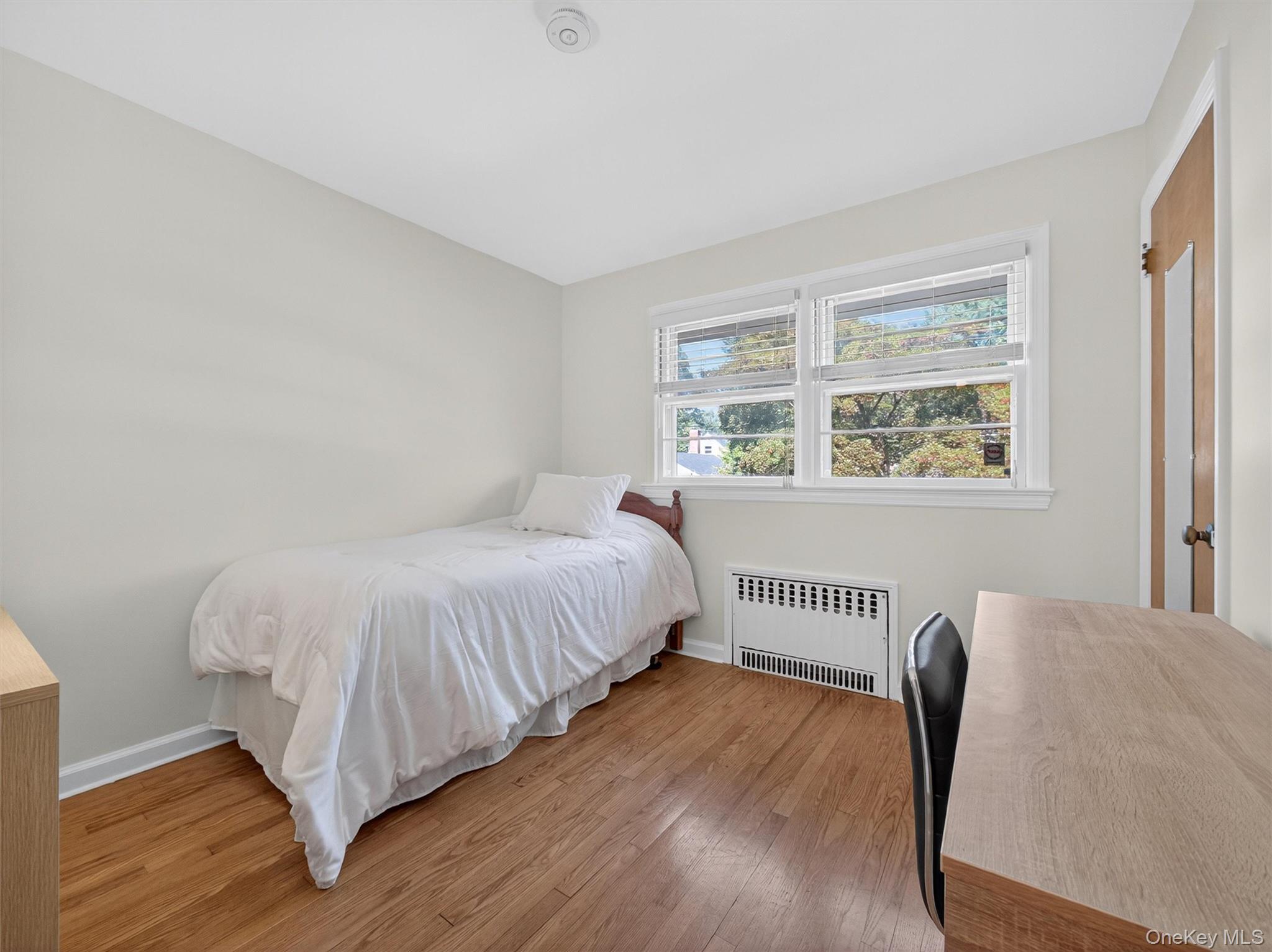 2 Beech Road Suffern, NY 10901 - Photo 13 of 24 a bedroom with a bed and wooden floor