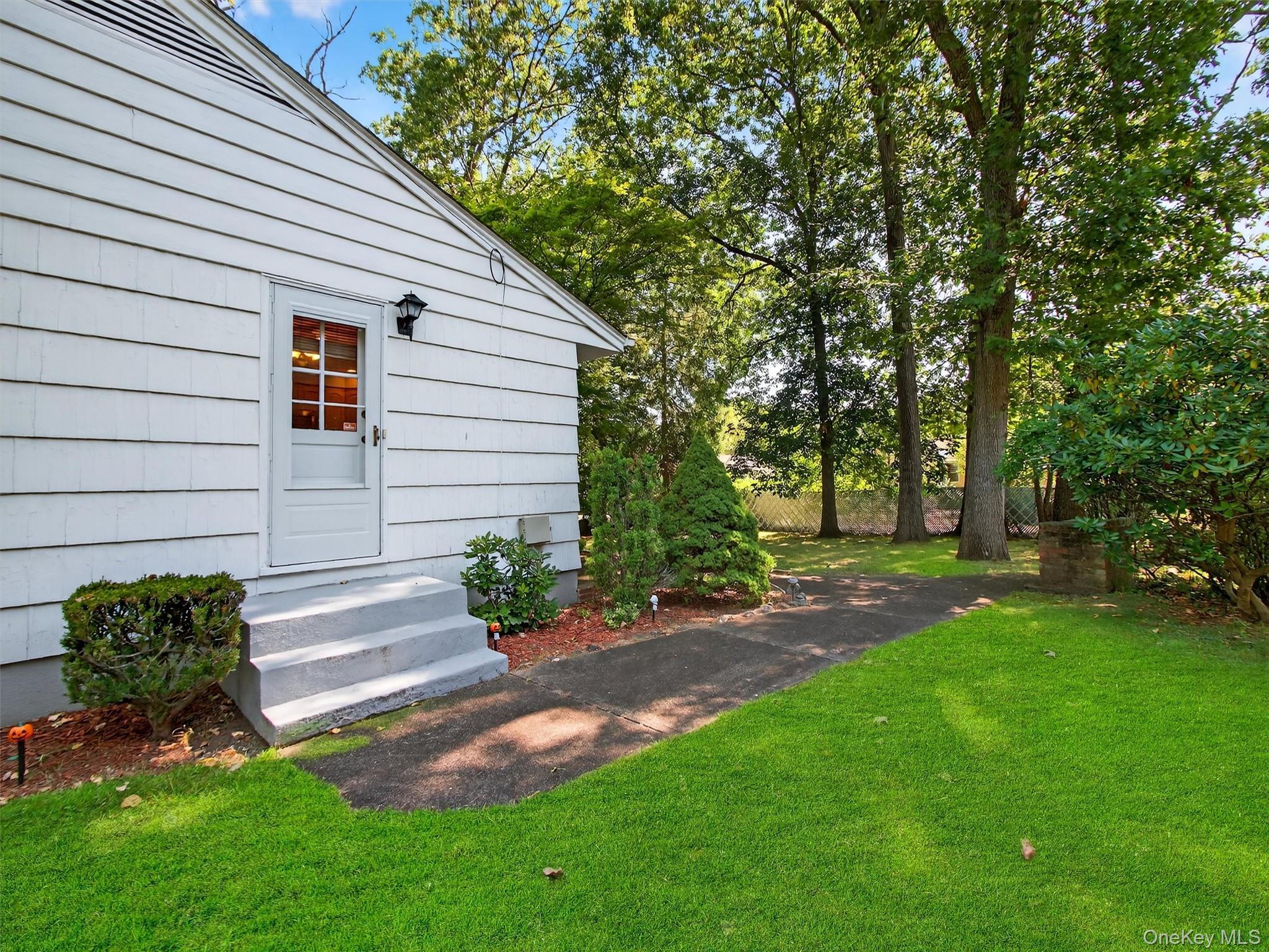 2 Beech Road Suffern, NY 10901 - Photo 18 of 24 a view of a backyard with plants and a tree