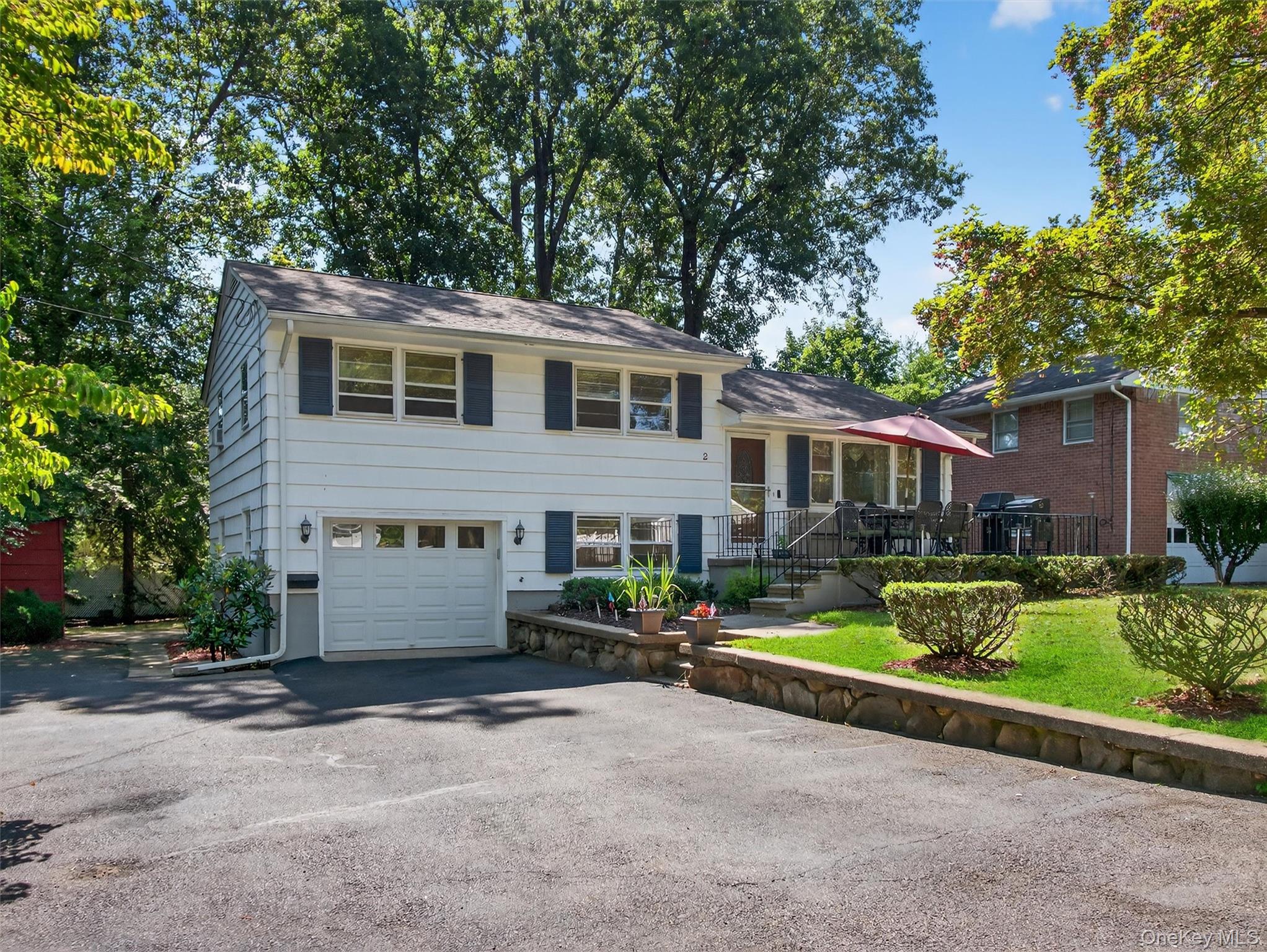 2 Beech Road Suffern, NY 10901 - Photo 3 of 24 a front view of a house with a yard and garage