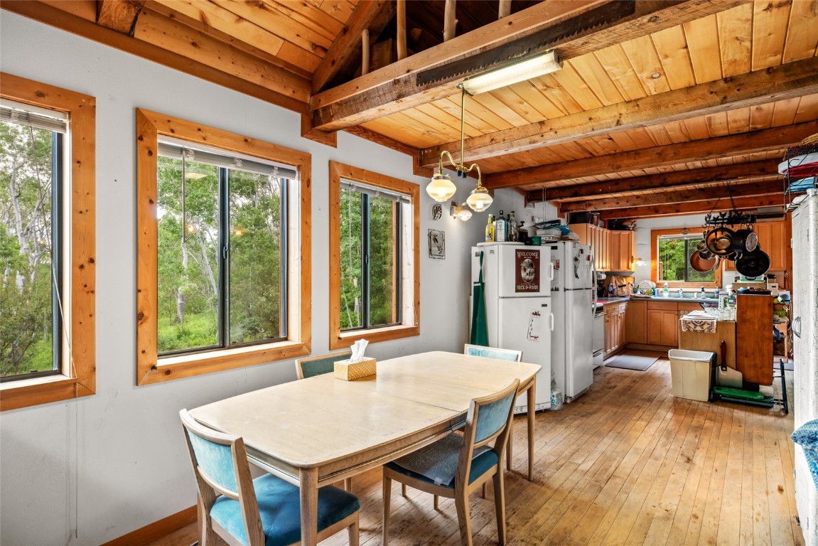 389 Routt Forest Loop Craig, CO 81625 - Photo 17 of 49 a view of a dining room with furniture window and wooden floor