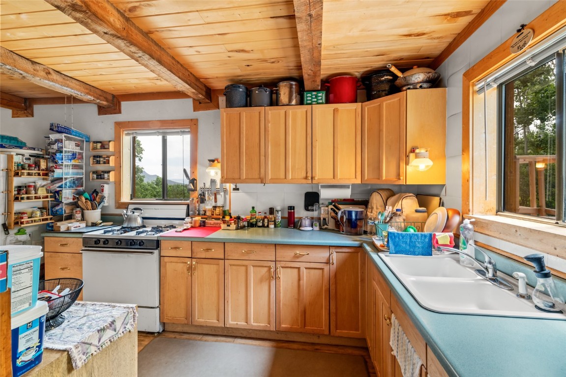 389 Routt Forest Loop Craig, CO 81625 - Photo 20 of 49 a kitchen with a sink stove and cabinets