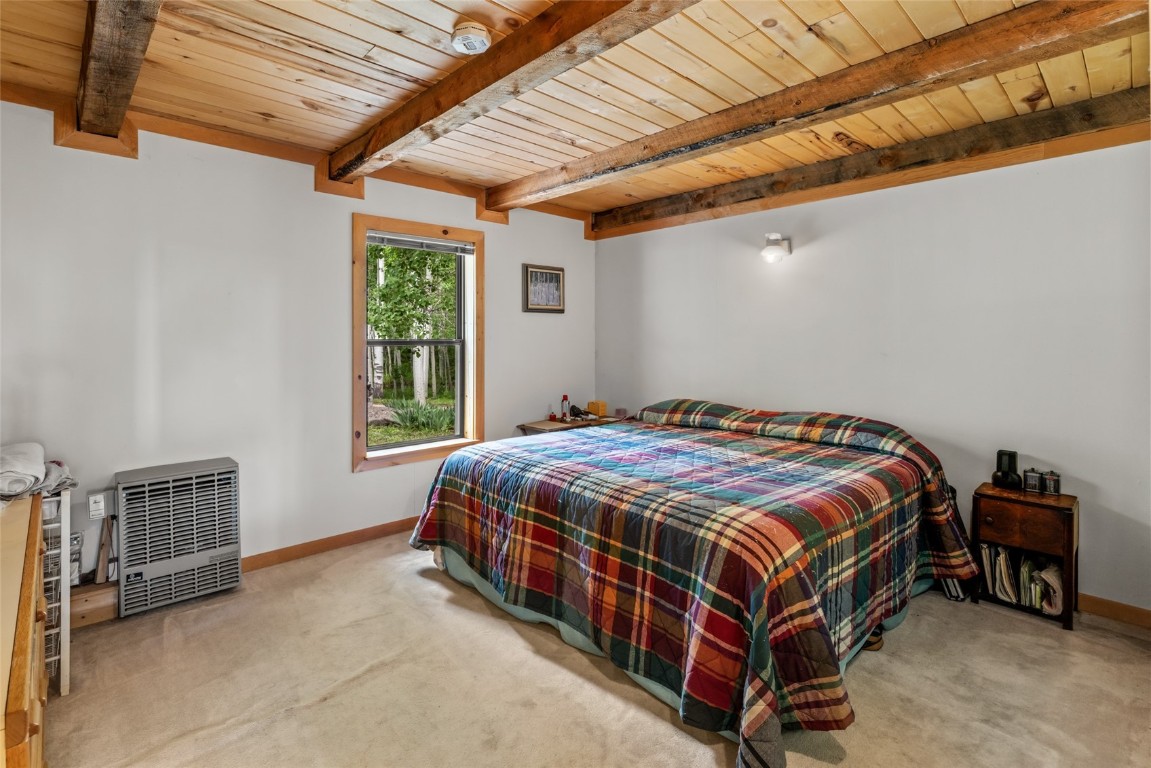 389 Routt Forest Loop Craig, CO 81625 - Photo 21 of 49 a bed sitting in a bedroom next to a window