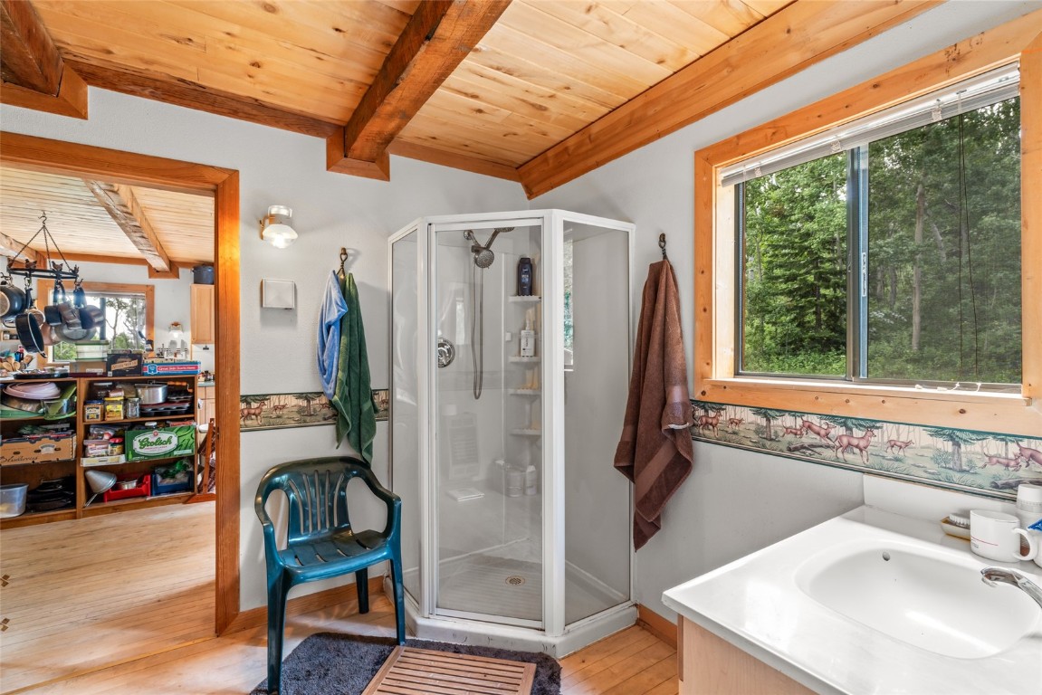 389 Routt Forest Loop Craig, CO 81625 - Photo 25 of 49 a bathroom with a sink a mirror and next to a window