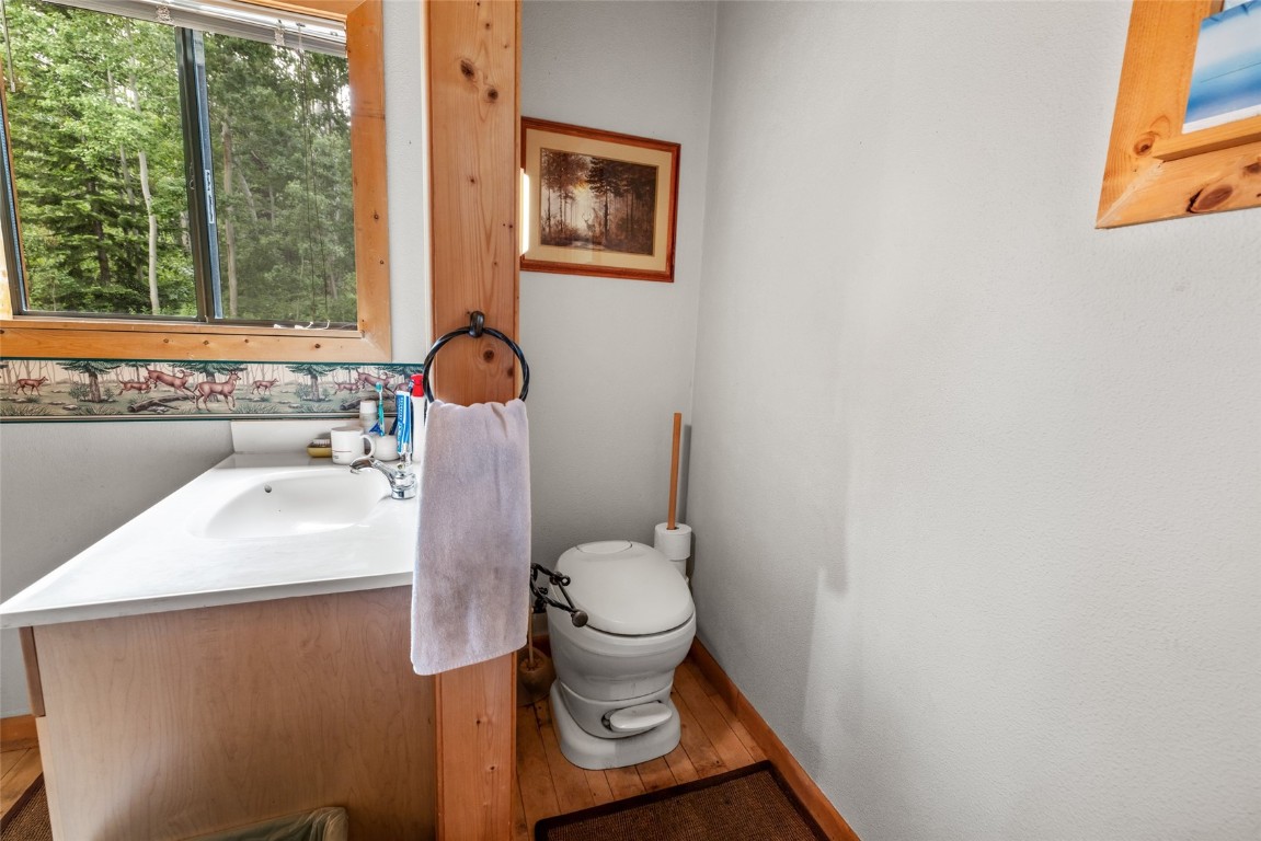 389 Routt Forest Loop Craig, CO 81625 - Photo 26 of 49 a bathroom with a sink toilet and window