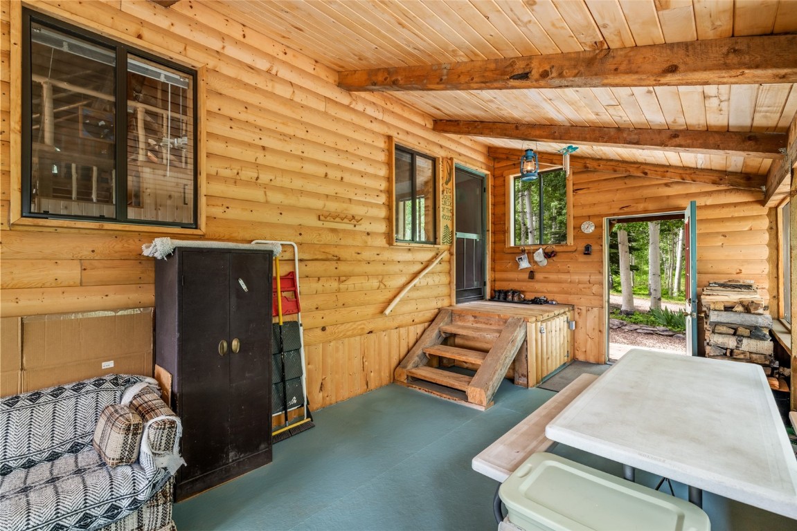 389 Routt Forest Loop Craig, CO 81625 - Photo 34 of 49 a view of a patio with couches and table and chairs with wooden floor