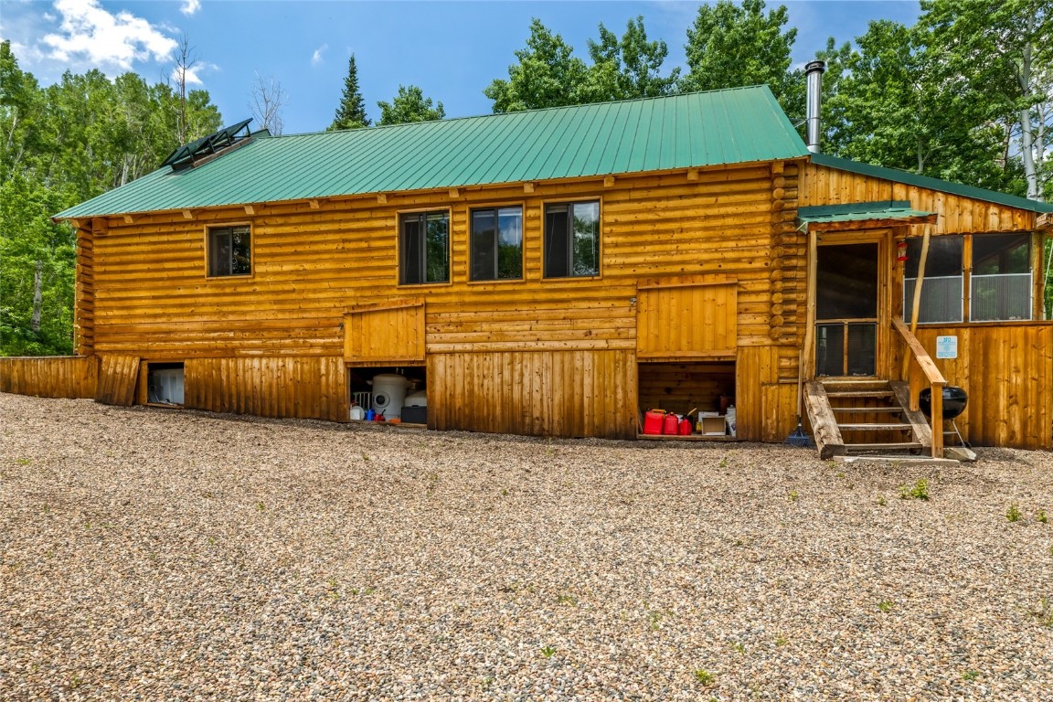 389 Routt Forest Loop Craig, CO 81625 - Photo 35 of 49 a view of a house with backyard and a tree