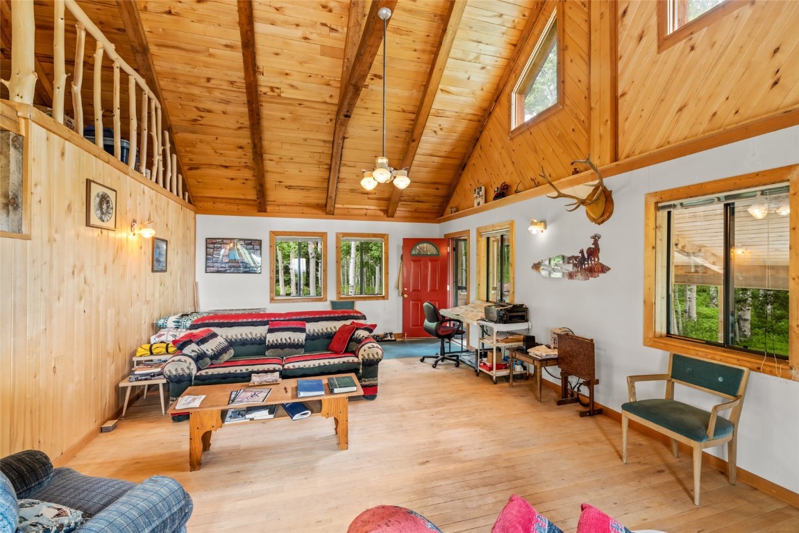 389 Routt Forest Loop Craig, CO 81625 - Photo 10 of 49 a reading room with furniture and a chandelier