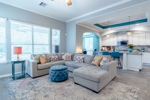 a living room with furniture and kitchen view