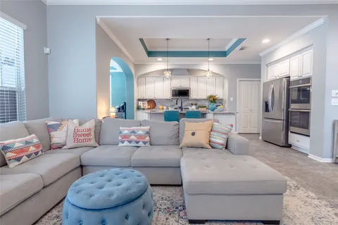 a living room with furniture fireplace and a view of kitchen