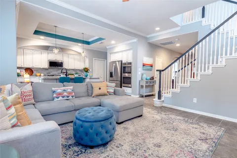a kitchen with kitchen island white cabinets and refrigerator