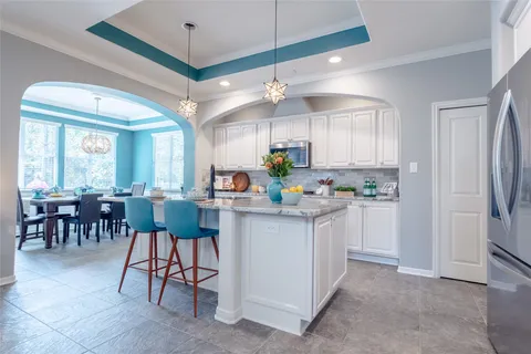 a kitchen with fireplace a sink and cabinets