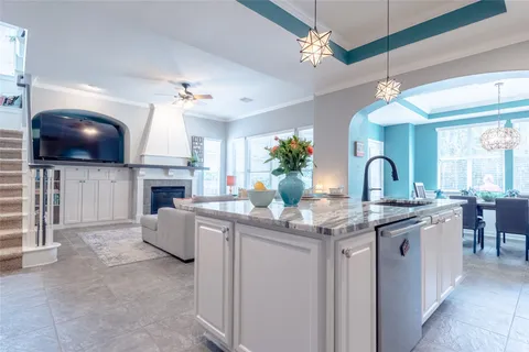 a kitchen with stainless steel appliances granite countertop a stove a sink a microwave and dining table