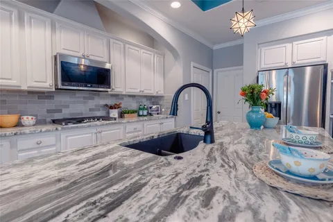 a dining room with furniture a chandelier and wooden floor