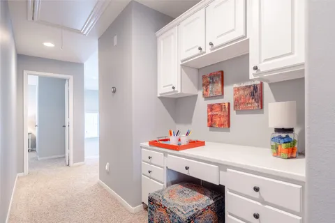 a bedroom with a bed and a lamp on dresser