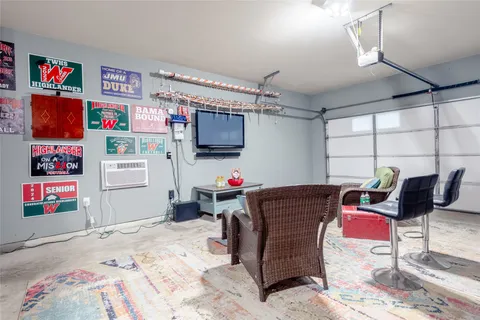 a view of a patio with couches table and chairs under an umbrella with a small yard
