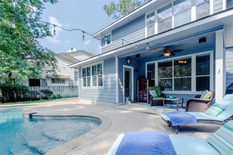 a swimming pool with outdoor seating and yard