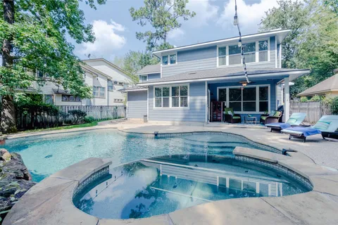 an aerial view of residential house with outdoor space and trees all around