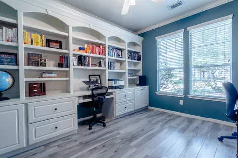 a view of a workspace with furniture and a window